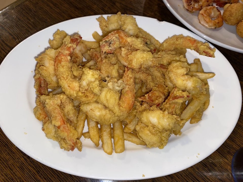 Plates of fried seafood on a restaurant table